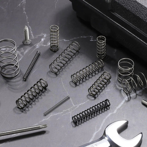 Ten Pack 7mm OD Compression Springs With 0.6mm Wire Diameter And 15mm Free Length in spring steel for DIY repairs on dark surface