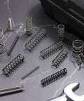 Beefed Up Heavy Duty Compression Springs Set 7mm Outer Diameter 1mm Wire 40mm Free Length Spring Steel scattered with tools