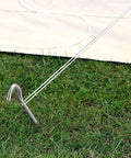 Heavy Duty 9 Inch Metal Tent Stake securing a garden canopy on grass