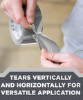 Person tearing white heavy-duty duct tape 1.88 in x 45 yd from a roll; versatile sealing and holding solution for metal, plastic surfaces.
