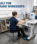 Heavy Duty Built Like A Tank Pneumatic Picture Frame Corner Joiner Machine Featuring Quick Toggle Automatic And Manual Settings Clean Cut Miter Corner Joining For Dedicated Woodworkers in an active workshop with frames.