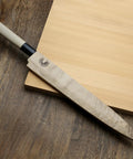 Yanagi knife with Premium Magnetic Oak Saya Cover for safe transport and storage, 270mm rugged blade protector on wooden surface.
