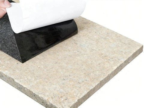 Heavy Duty Three Pack 6x24 Inch Non Slip Stair Treads With Black High Traction Adhesive Tape being applied to stone surface