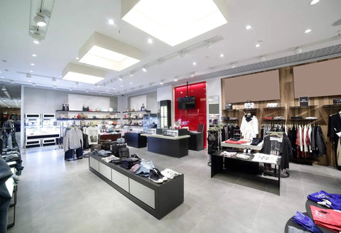 Modern clothing store interior with ceiling lights, showcasing BR30 LED Light Bulb 10W 3000K Warm White Frosted Finish Dimmable