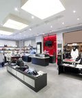 Modern retail store interior showcasing apparel and accessories with bright illumination from overhead lights.