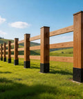 Wooden fence with 4x4 Fence Post Ground Spike Anchor Pack, Black Powder Coated Finish, set in a grassy field, sunny sky.
