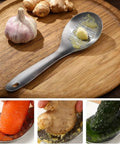 Ginger Grater Spoon And Lime Zester With Garlic Press And Wasabi Grinder on a wooden board, showcasing garlic and ginger use.