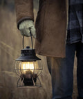 Person holding Antique Bronze LED Camping Lantern With Rechargeable Battery And USB Power Vintage Inspired Outdoor Light