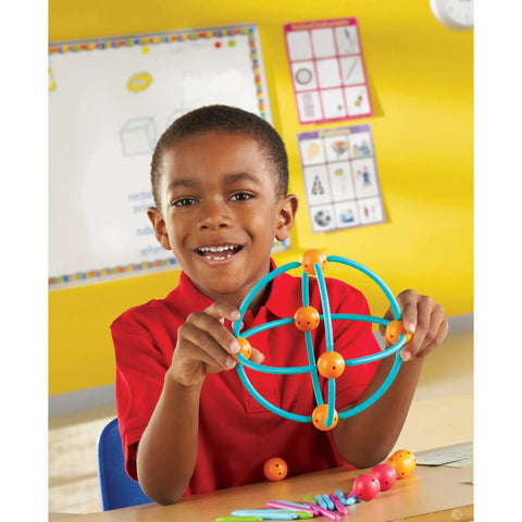 Child using Geometric Shapes Building Set For Kids Ages Five And Up 170 Pieces Kid Friendly Hands On Math Learning Kit to form a sphere.