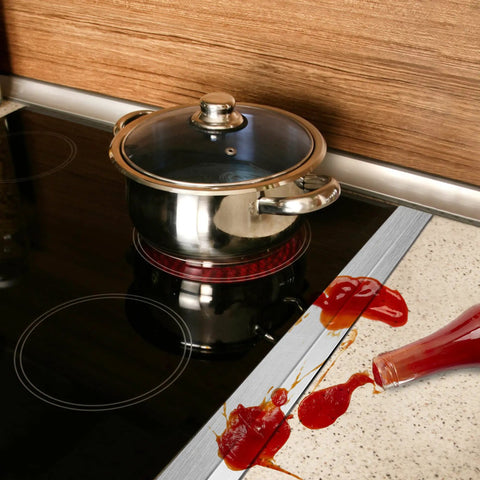 Stainless Steel Stove Gap Covers 23.5 Inches Set installed between stove and counter, catching spilled sauce, heat resistant, easy to clean.
