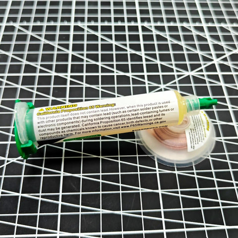 No Clean Soldering Flux Paste And Desoldering Wick Kit with flux tube and braided copper wick on grid surface