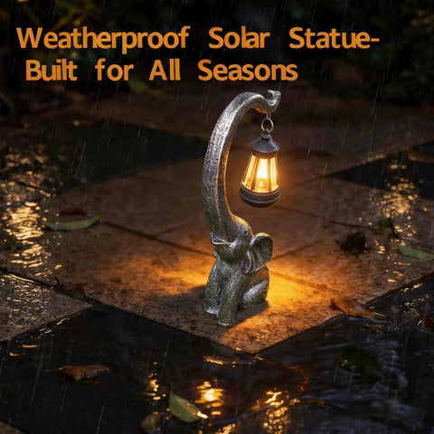 Outdoor Solar Powered Elephant Garden Statue With LED Lantern Lights in rain, glowing on wet patio, made of waterproof resin