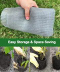 Hand holding rolled 3 Gallon Gopher And Mole Proof Wire Baskets 5 Pack Stainless Steel Underground Root Guard Mesh Baskets For Garden Beds.
