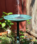 28 Inch Tall Outdoor Bird Bath With Solar Water Fountain Plastic Retro Green Bird Bath in garden setting.