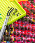 4 Piece Rubber Coated Tweezers Set With Straight Point Flat Tip And Long Bent Tips For Crafts Beads Stamps Jewelry Making DIY Projects Snag Free Grip And Delicate Tweezers For Fine Pickups in use with multicolored craft beads and green tray
