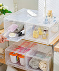 Sleek Stackable Clear Hat Organizer Two Pack With Smooth Glide Drawers Holds A Dozen Baseball Caps Each For Your Streetwise Headgear Vault And Game Day Ready Setup on shelf displaying various items.