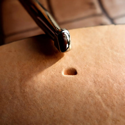 Close-up of leather beveling tool with alloy steel head creating an impression, part of Leather Beveling Tools And Stamp Set With Alloy Steel Precision Heads