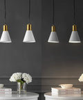 Mid Century Modern Iron LED Pendant Light with Sleek Black Metal Shade above elegant table setting with books and flowers