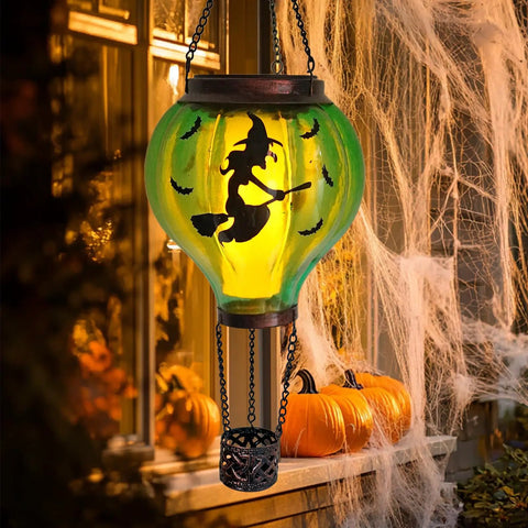 Halloween Outdoor Decoration Hot Air Balloon Solar Lantern with flickering flame and witch design on a porch.