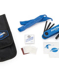 On The Go Cyclist Essential Tool Kit with tire levers, hex screwdriver, tire boots, patches, and a black wallet for quick repairs