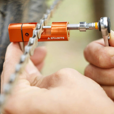 Stash Bike Chain Tool Kit With Hidden Handlebar Storage For Quick On The Go Repairs being used to fix a bicycle chain close-up