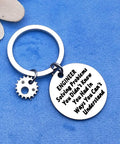 Engineer Keychain Gift For Engineers And Engineering Students Funny Yet Practical Solves Problems You Didnt Know You Had In Ways You Cant Understand Mechanical Architect Construction Pro Gift For The Gearhead In Your Life. Silver pendant with engraved text on blue fabric.