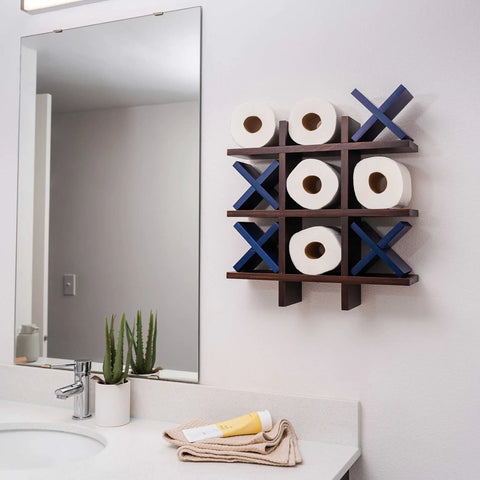 Tic Tac Toe Toilet Paper Holder Dope Wall Mounted Storage for Bathroom Decor with blue X's and toilet paper rolls over sink.