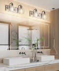 Chrome Vintage Two Light Vanity Fixture With Clear Glass Globe Shades mounted above a modern double sink bathroom vanity.