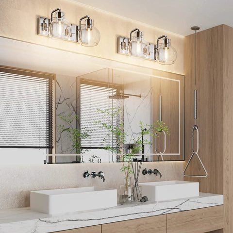Chrome Vintage Two Light Vanity Fixture With Clear Glass Globe Shades mounted above a modern double sink bathroom vanity.