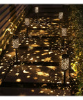 Six Pack Solar Powered Outdoor Pathway Lights Waterproof Black Lanterns For Garden Yard Driveway Patio And Walkway Three In One Multipurpose Use Your Go To Halloween Gift For Porch Outdoor Decor casting star and moon patterns on walkway