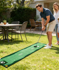Man putting on Indoor Golf Putting Mat Set With Telescoping Putter Mini Golf Green Kit Putting Cup 2 Practice Balls in backyard
