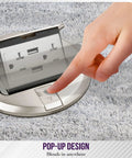 Hand pressing button on Round Pop-Up Floor Box Kit With 6 Inch Diameter Cover 20A Tamper-Resistant USB Receptacle