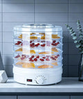Heavy Duty Electric Food Dehydrator With Five Clear Trays And Adjustable Heat Zones For Zero Fuss Drying Of Fruit Meat Jerky And Custom Pet Treats Perfect For Family Dinners And Weekend Meal Prep, showing transparent trays with dried fruit.