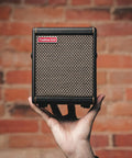 Person holding Spark MINI 10W Portable Guitar Amp And Bluetooth Speaker With 8 Hour Battery Life, perfect for home or on the go.