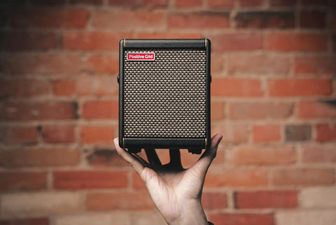 Person holding Spark MINI 10W Portable Guitar Amp And Bluetooth Speaker With 8 Hour Battery Life, perfect for home or on the go.