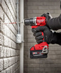 Person using M18 Compact Brushless Hammer Drill Driver With Half Inch Metal Chuck And All Metal Gear Case for brick wall drilling.