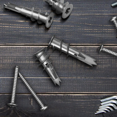 Close-up of 100 Pcs Zinc Self Drilling Drywall Anchors With 8 Stainless Steel Screws Kit For Hanging Up To 50 Lbs on wooden surface