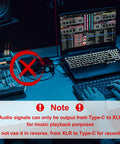 Setup with laptop, DJ console, and USB C to Dual XLR Male Audio Cable for Amplifiers and Mixers, 6ft, note on usage.