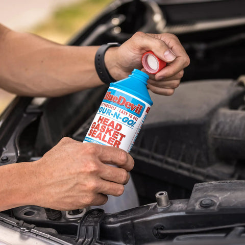 Hands pouring Pour N Go Head Gasket Sealer 16 Ounce Easy Do It Yourself Formula That Permanently Seals Engine Leaks No Tools Needed For Quick Long Lasting Car Maintenance into engine
