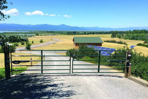 Heavy Duty Solar Dual Automatic Gate Opener Kit For Swing Gates Up To 20 Feet With 10 Watt Solar Panel Included DIY Residential Driveway Gate Opener For Gates Up To 900 Pounds And 12 Feet Long Max 24 Feet Opening Plug And Play at countryside driveway with solar panels visible