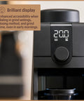 Pro Tier Stepless Grind Adjustment Coffee Grinder Featuring Precision Steel Burrs And Quick Release Design For Smooth Shot Pulling Or Effortless Daily Brewing In Slick Black Finish with a clear display panel for grind settings.