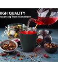 Set Of Six Ceramic Coffee Mugs 12 Oz For Home And Office Modern Matte Black Exterior With Bright Interior Large Cups For Coffee Tea Cappuccino And More For Your Daily Grind Le Papillon Collection with tea being poured into one shown with ingredients.