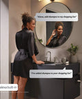 Woman using Alexa built-in feature on mirror in bathroom, surrounded by modern decor, focus on smart home interaction.
