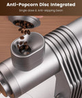 Slick Single Dose Espresso Grinder Featuring Variable Speed Stepless Control And A 64 Mm Titanium Flat Burr pouring coffee beans.