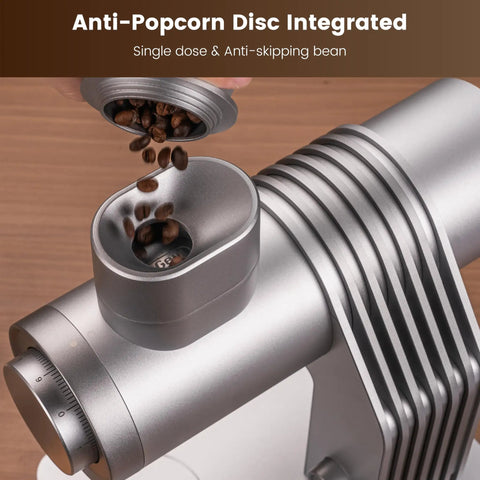 Slick Single Dose Espresso Grinder Featuring Variable Speed Stepless Control And A 64 Mm Titanium Flat Burr pouring coffee beans.