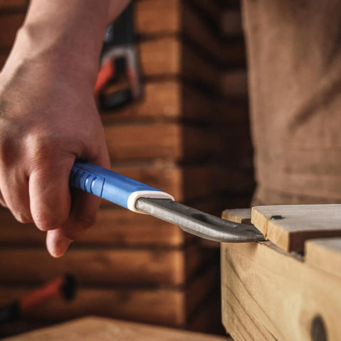 Using the 10 Inch Nail Puller Cats Paw Pry Bar With Magnetic Hammer Head Crowbar for prying baseboards in a woodwork setting.