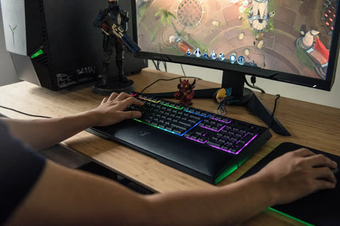 Badass Gaming Keyboard Featuring Mechanical Membrane Keys Dope RGB Lighting with hand on keys during gameplay.
