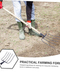 Gardener using Multi Use Manure Fork For Lawn Care And Rural Property Maintenance Heavy Duty Iron Pitchfork For Clearing Debris