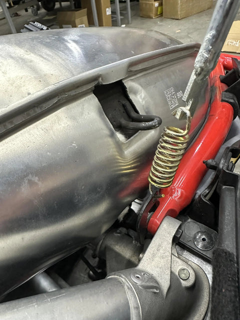 Push Industries 102.302 exhaust spring removal tool, steel coil handle mounted on motorcycle exhaust