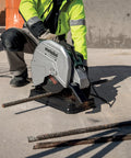 Worker using 14-Inch Metal Chop Saw With Quick Clamp And Variable Mitre For -15 To 45 Degree Cuts on steel rebar.